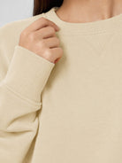 YUCOLEN Women's Fleece Lined Crewneck Sweatshirt with Thumb Holes Loose Fit Pullover in Light Apricot