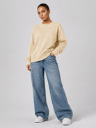YUCOLEN Women's Fleece Lined Crewneck Sweatshirt with Thumb Holes Loose Fit Pullover in Light Apricot